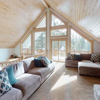 Upstairs loft with sofas and and lots of natural light from the windows.