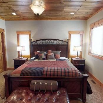 The master bedroom is located on the main floor with a King bed and large window to enjoy the beautiful surroundings.