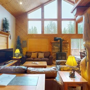 Imagine stepping into a cozy yet expansive open living room in a cabin, where rustic charm meets modern comfort.