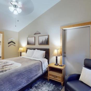 Second bedroom with a queen size bed, seating, and closet.