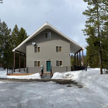 Beautiful cabin that is nestled in the towering pine trees.
