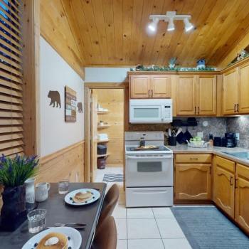 A full kitchen with appliances and dining table to enjoy.