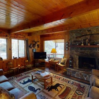 The living room offers a cozy space to unwind after a long day. A fireplace is included be sure to bring your own wood.