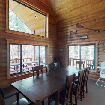Large dining table that seats 8 with additional seating at the kitchen island.