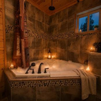 Indulge in a luxurious, candlelit bubble bath in the deep soaking tub, surrounded by beautiful custom tile work and warm natural wood walls.