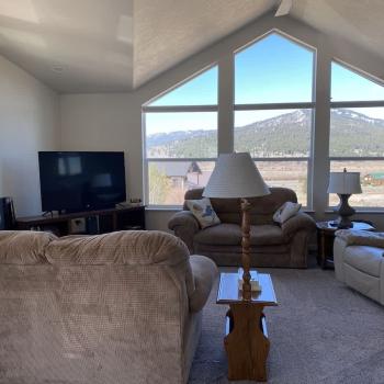 Living room area with seating and tv for entertainment.