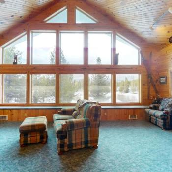 Natural light pours in through large windows, tying it all together with a view of the forest just beyond.
