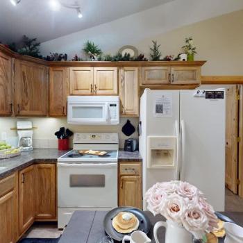 A full size kitchen with a dining room table to seat everyone.