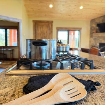 Basic cooking essentials with pots and pans, dishes, silverware, and small appliances.