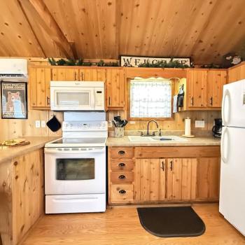 Full kitchen with appliances, cookware, dishes, silverware, and basic spices.
