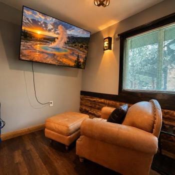 Kick back in the plush leather armchair and ottoman to enjoy movie night on the large wall-mounted Smart TV, complete with a private, cozy viewing angle.