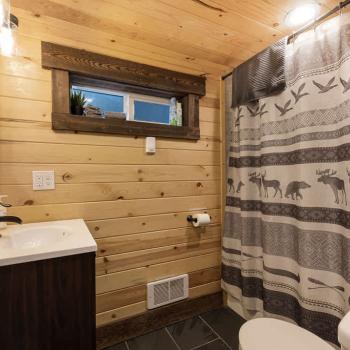 Full size bathroom with hot water on demand and a deep bathtub for soaking.