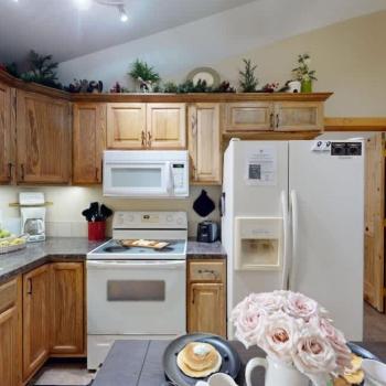 A full size kitchen with a dining room table to seat everyone.