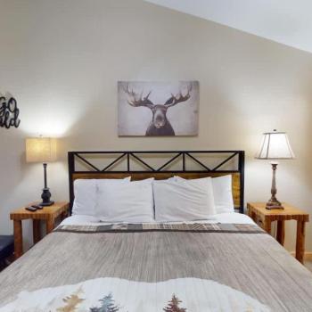 First bedroom with a king size bed, seating, and closet space.