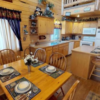 Upon entrance, you are greeted by the dining table and kitchen.