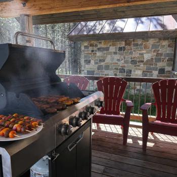 Propane grill on the front porch and seating.