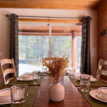 Dining table with seating for up to 8 people with 6 additional seats at the kitchen island.