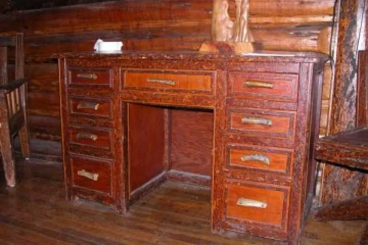 A handmade desk inside the Johnny Sack Cabin, its trim still in bark
