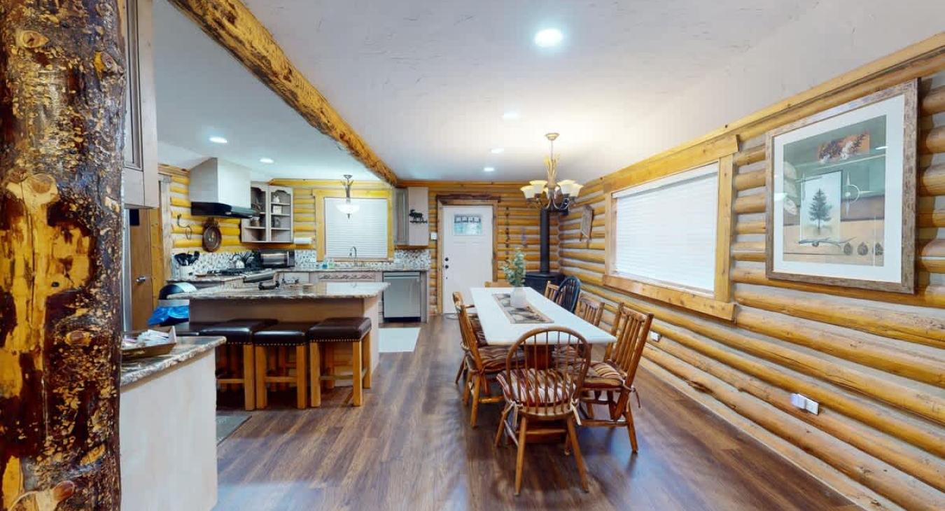 Large open kitchen and dining area equipped to host a home cooked meal.