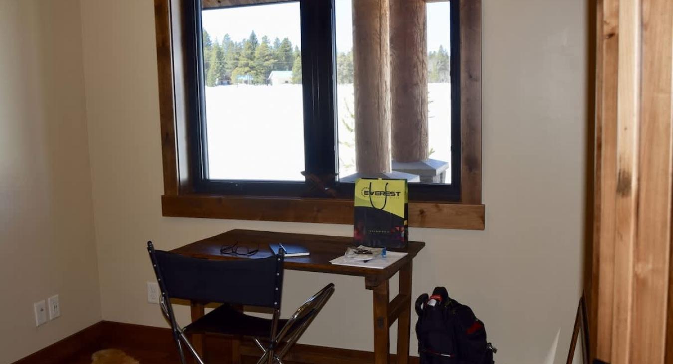 Small office with desk and beautiful window to look out of.