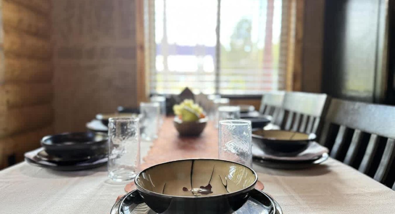 Dining room table is located adjacent to the cabin. Perfect for up to 7 people with additional seating at the island.