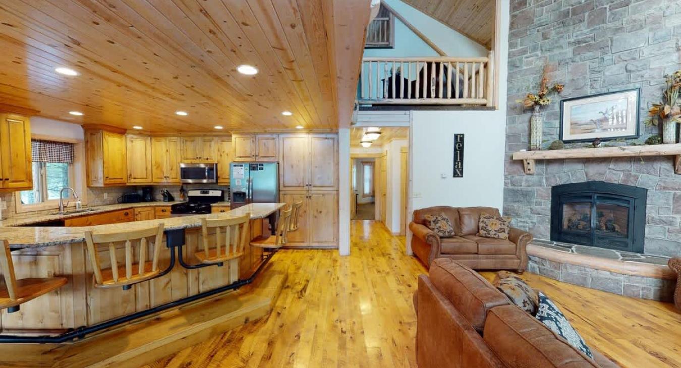 The open kitchen blends seamlessly into the cabin's cozy living area, creating a welcoming space perfect for gathering and unwinding.