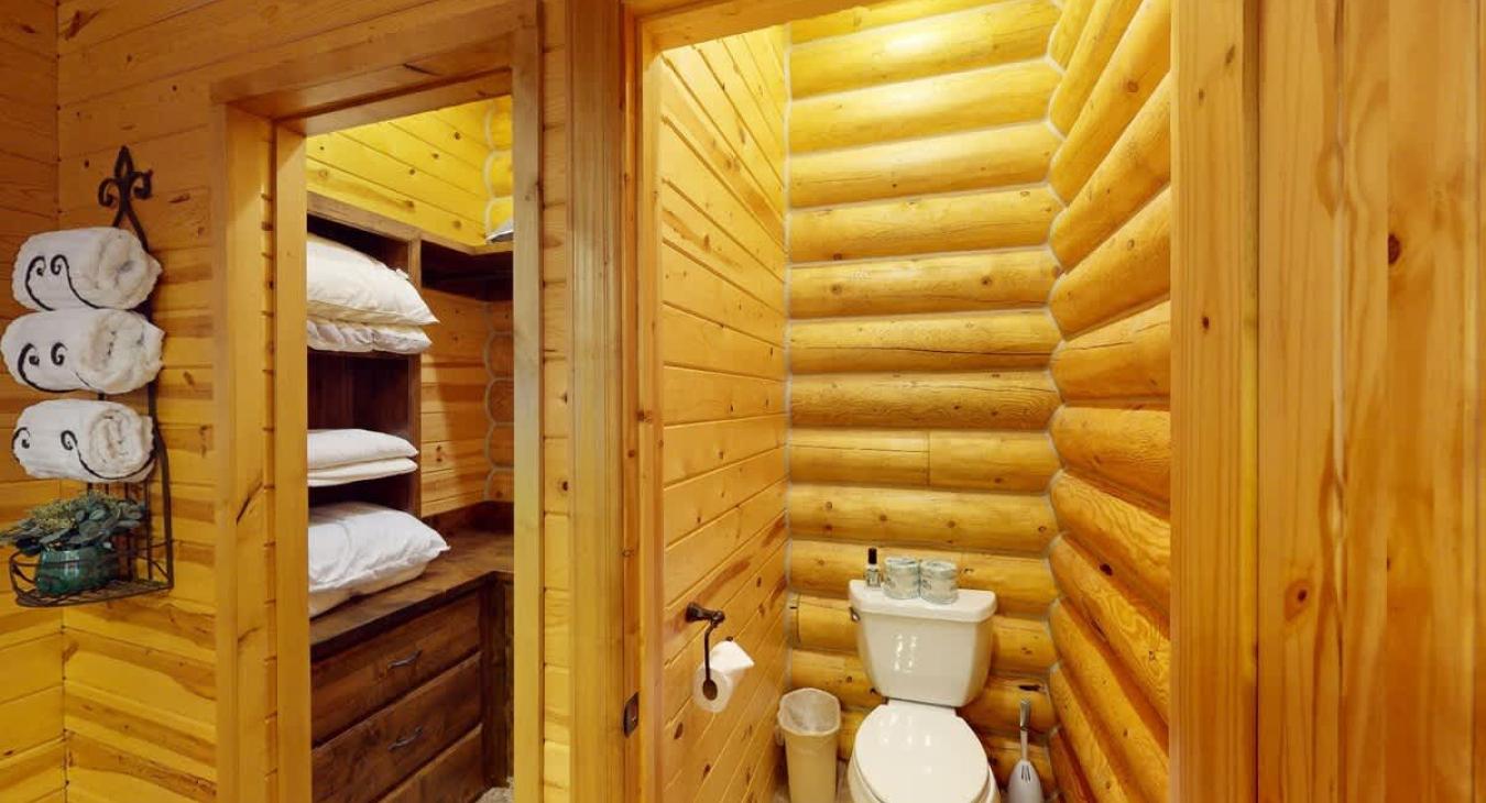 To the right of the closet there is a small toilet with a door for added privacy.