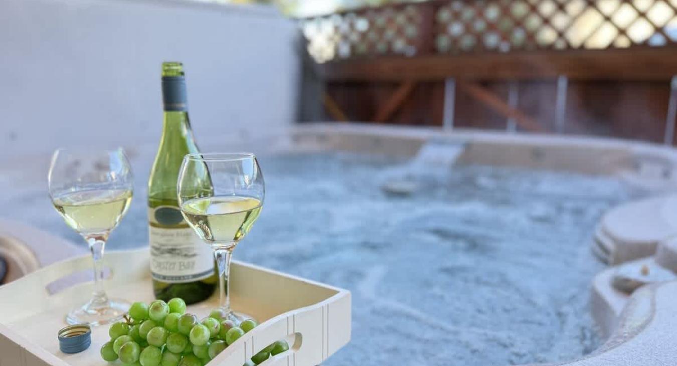 Unwind and relax in the hot tub that is located outside cabin.