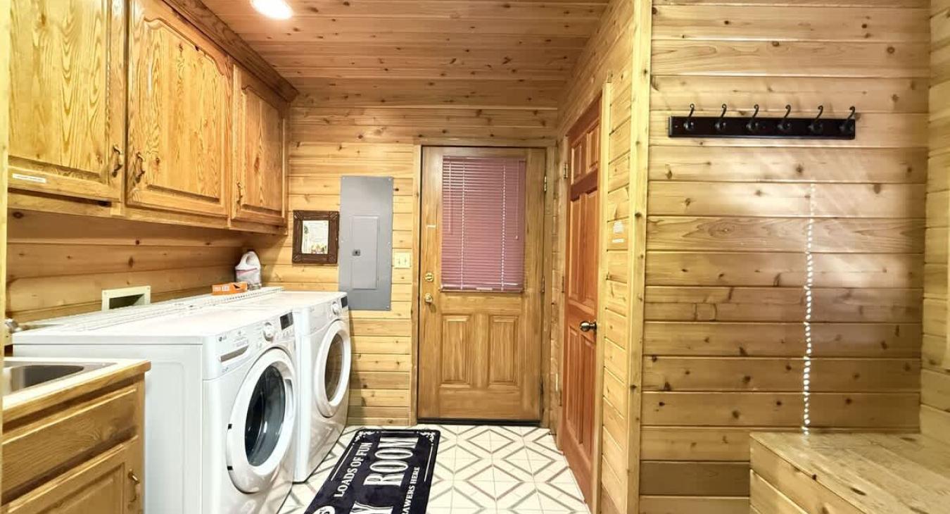 Laundry room with full size washer and dryers with provided laundry soap.