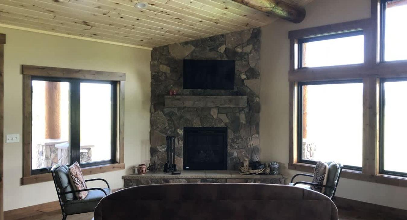 Living room with seating, fireplace, and tv.