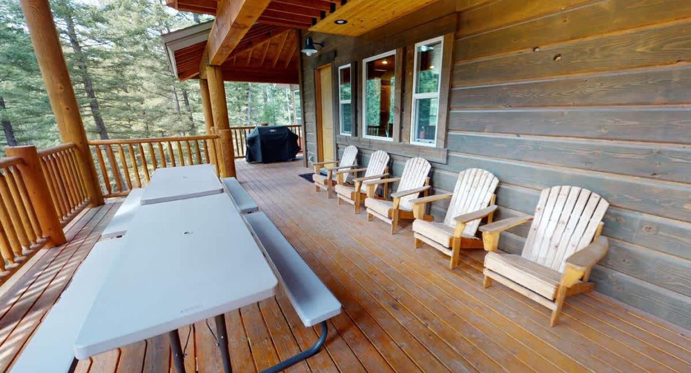 Large deck with seating and a table to enjoy your meals with beautiful views.