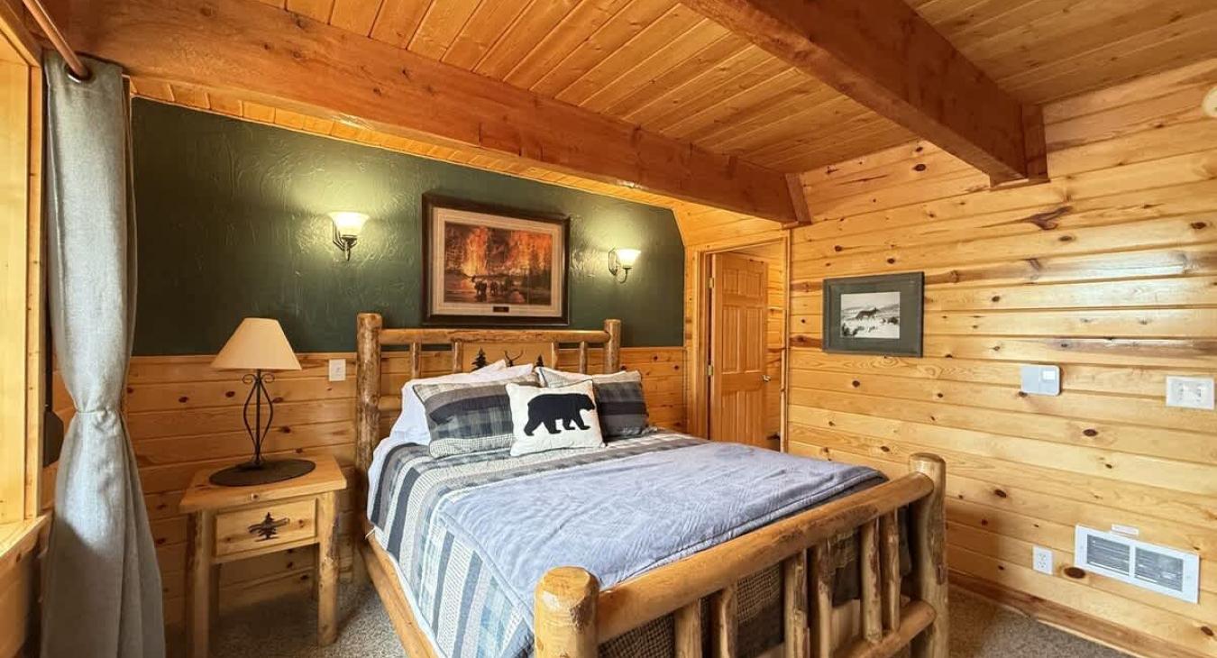 Downstairs bedroom with a queen bed.