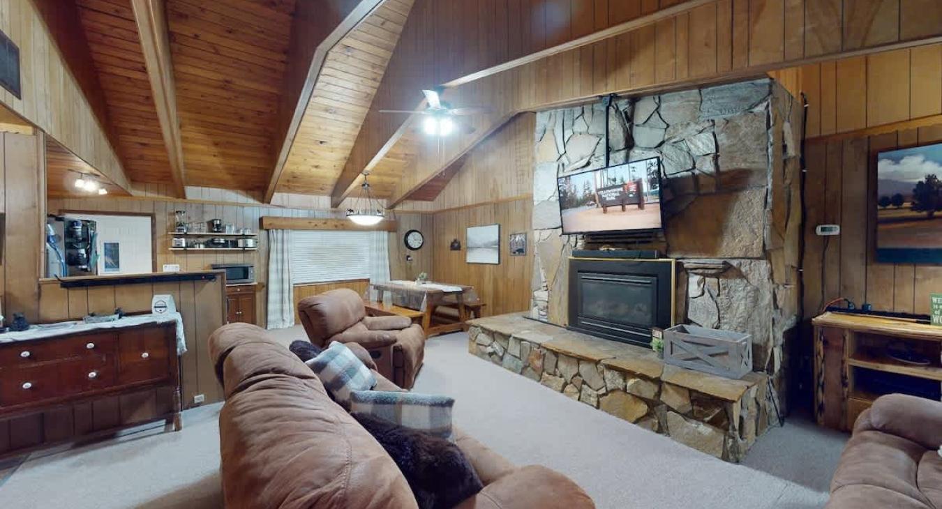 Beautiful living room with a fireplace and seating. Make sure to bring your own wood.