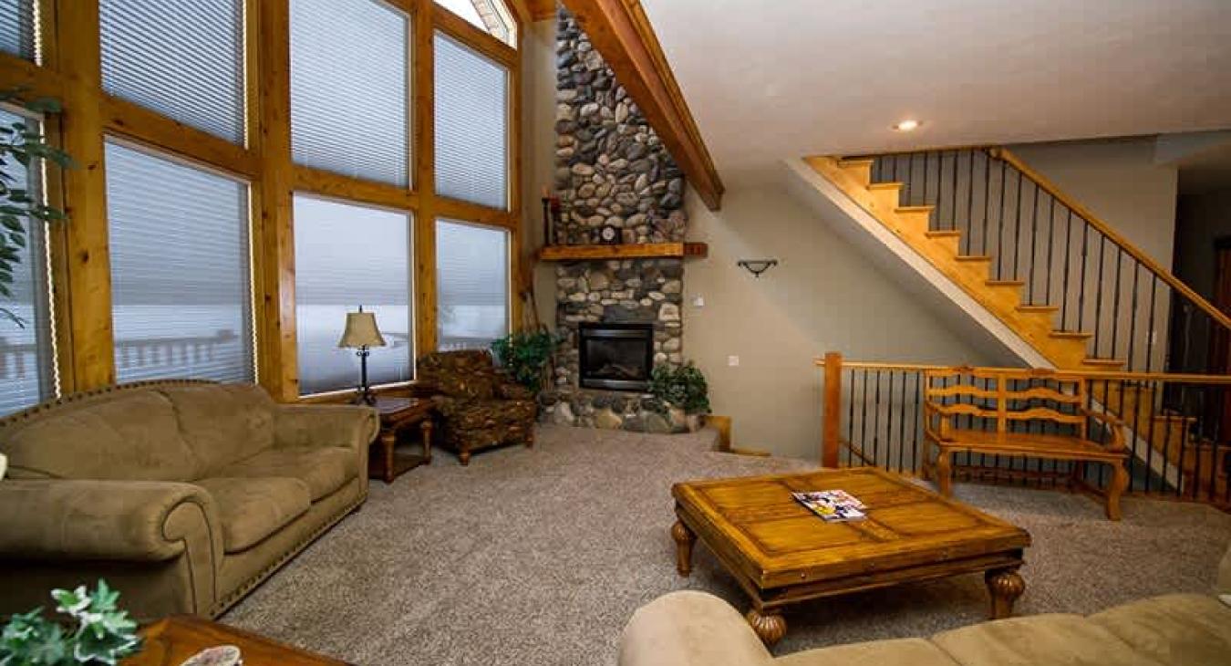 Living room main floor with seating and lots of natural light.