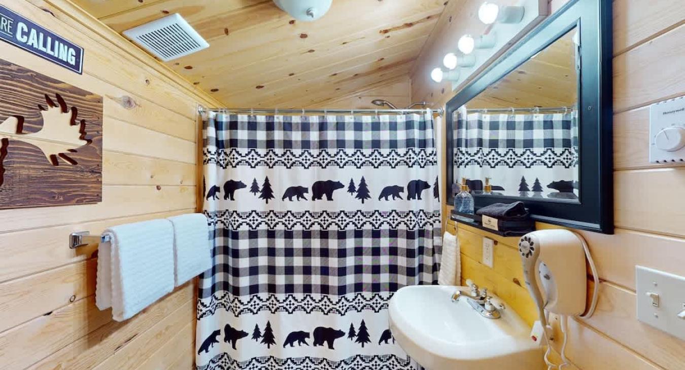 Full size bathroom with a shower tub combo, toilet, and sink.