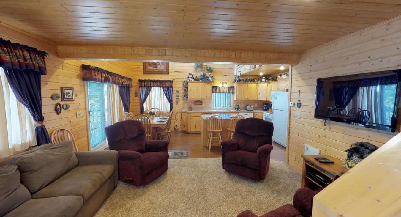 The open living rooms blends seamlessly into the cabin's cozy kitchen, creating a welcoming space perfect for gathering and unwinding.