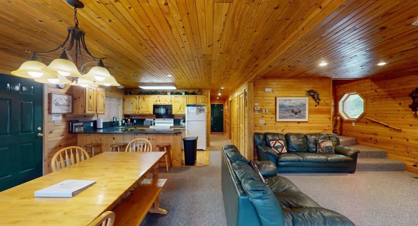 The open kitchen blends seamlessly into the cabin's cozy living area, creating a welcoming space perfect for gathering and unwinding.