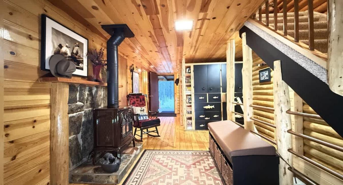 Entryway with gas fireplace and stairs. Gas fireplace to keep you warm during your stay.