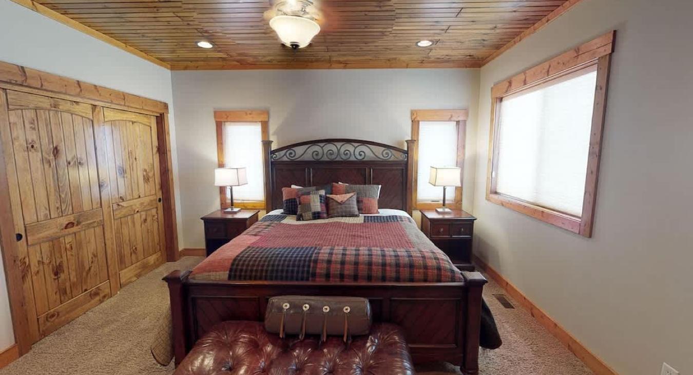 The master bedroom is located on the main floor with a King bed and large window to enjoy the beautiful surroundings.