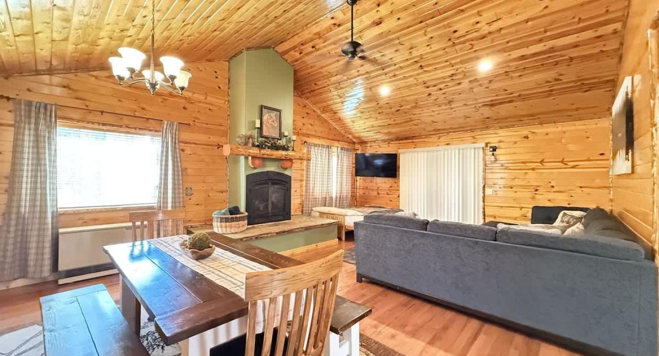 Upon entrance you are greeted by the dining table and living room. Living room also includes a Futon with a Full bed.