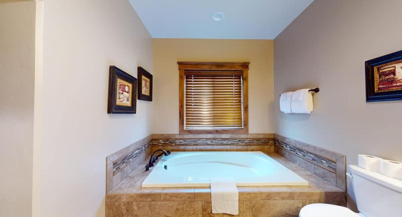 Ensuite bathroom with soaking tub to relax after a day outdoors.
