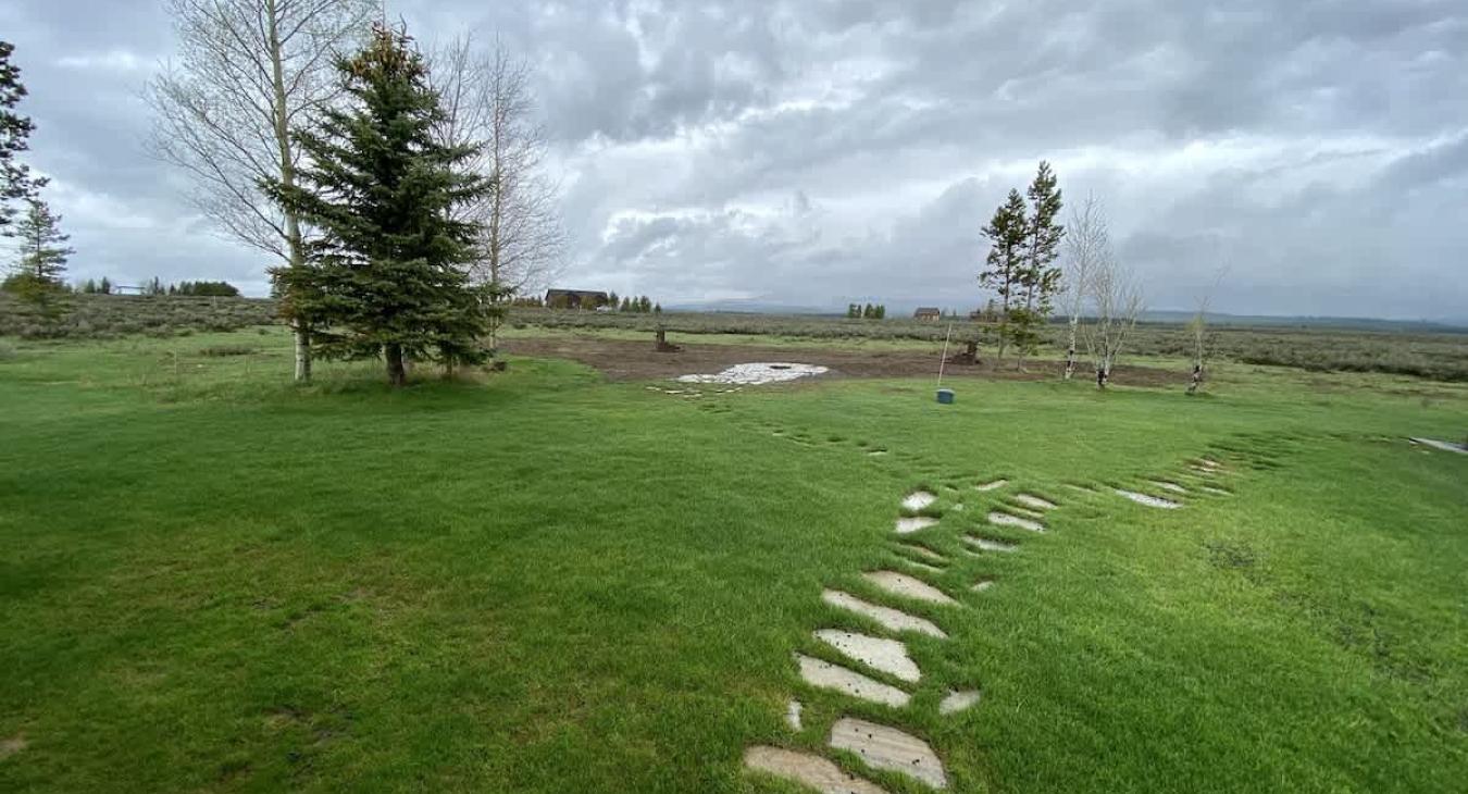 From the outside there is a stone path to take in the beautiful scenery of the cabin.