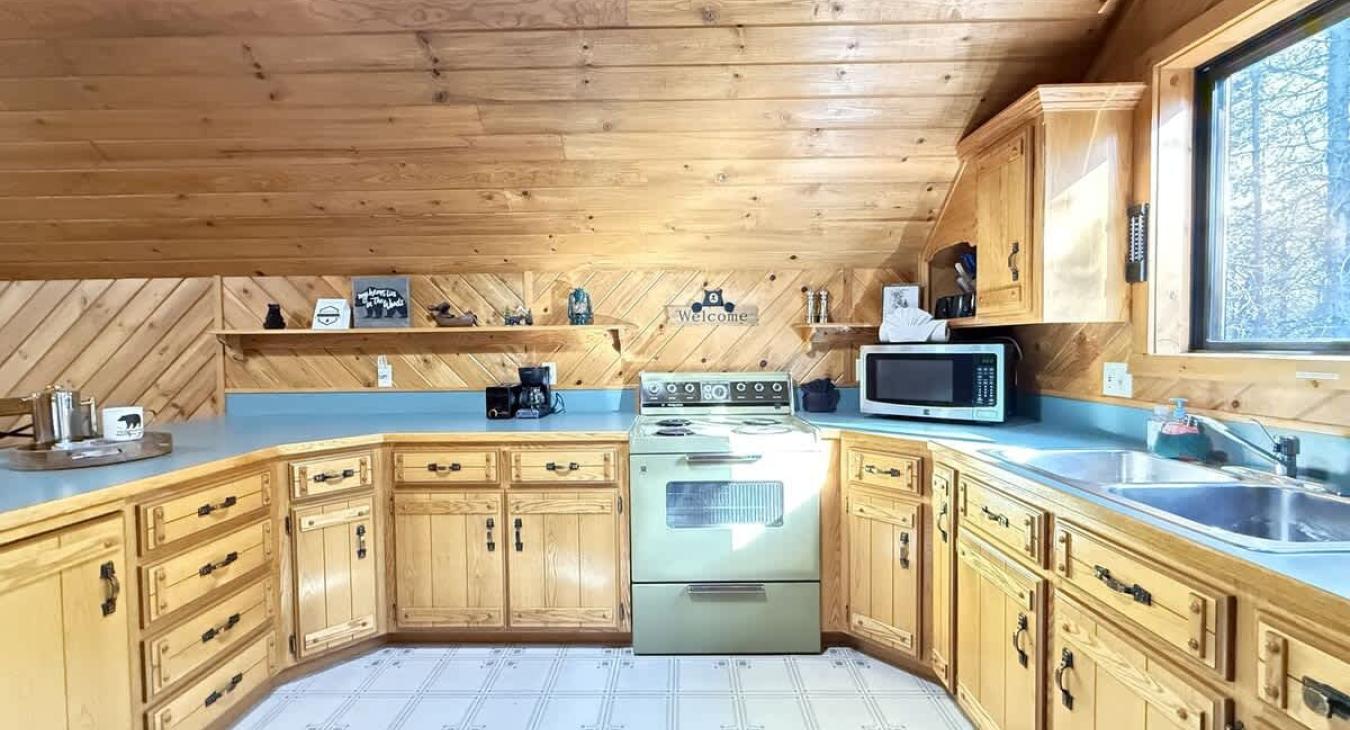 Upstairs garage apartment kitchen. Full kitchen with appliances, dishes, and basic cooking needs.