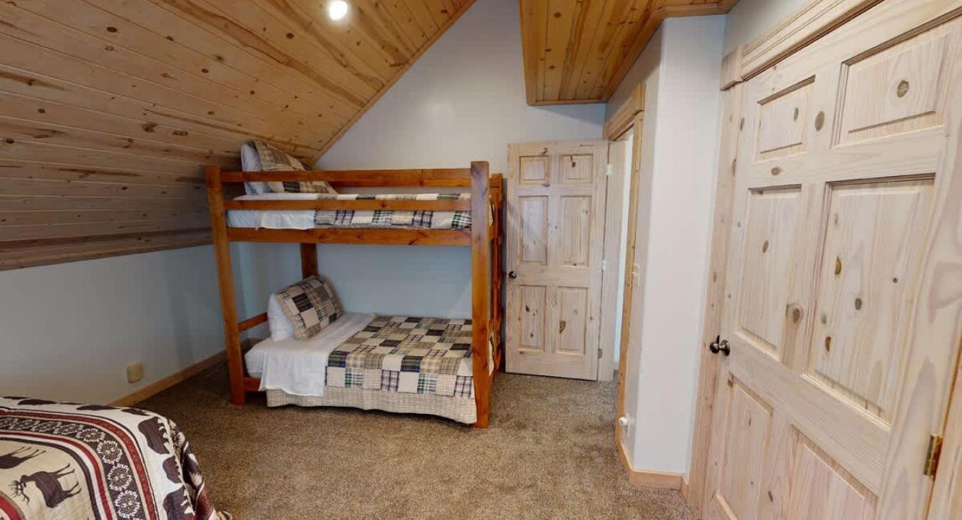 Bedroom #1 located upstairs with a Queen and bunk bed.