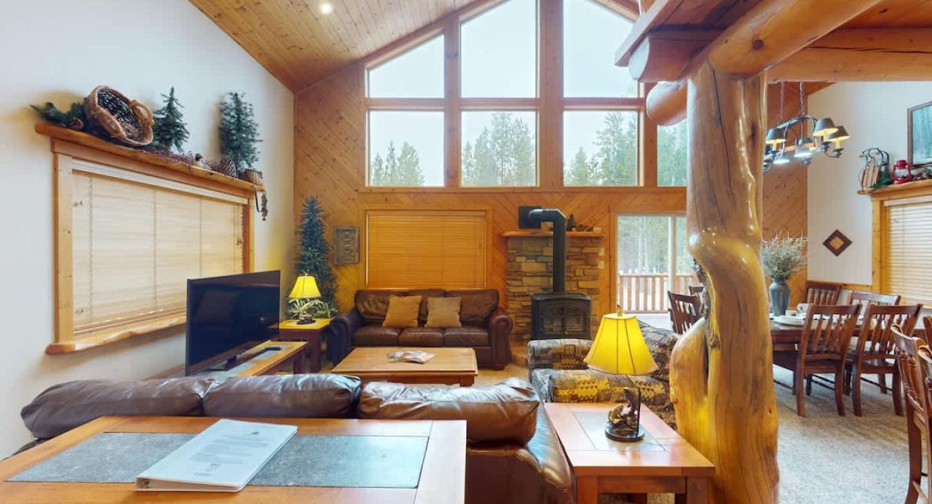 Imagine stepping into a cozy yet expansive open living room in a cabin, where rustic charm meets modern comfort.