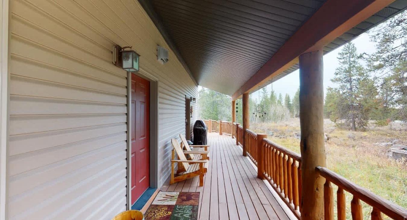Beautiful open deck with a grill and seating.