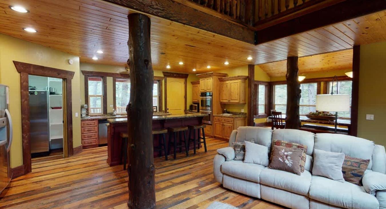 The open living room blends seamlessly into the cabin's cozy kitchen, creating a welcoming space perfect for gathering and unwinding.