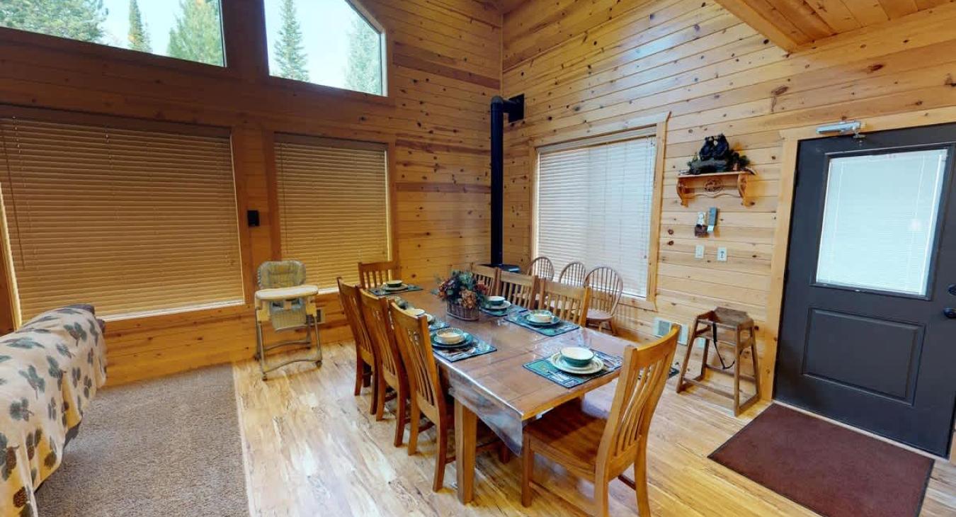Dining room table located adjacent to the kitchen with seats for up to 8 people. Additional seating is available at the kitchen island.