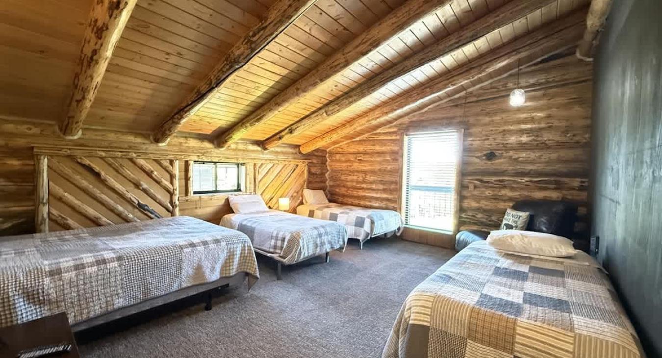 The first bedroom has 3 twins and 1 queen bed.