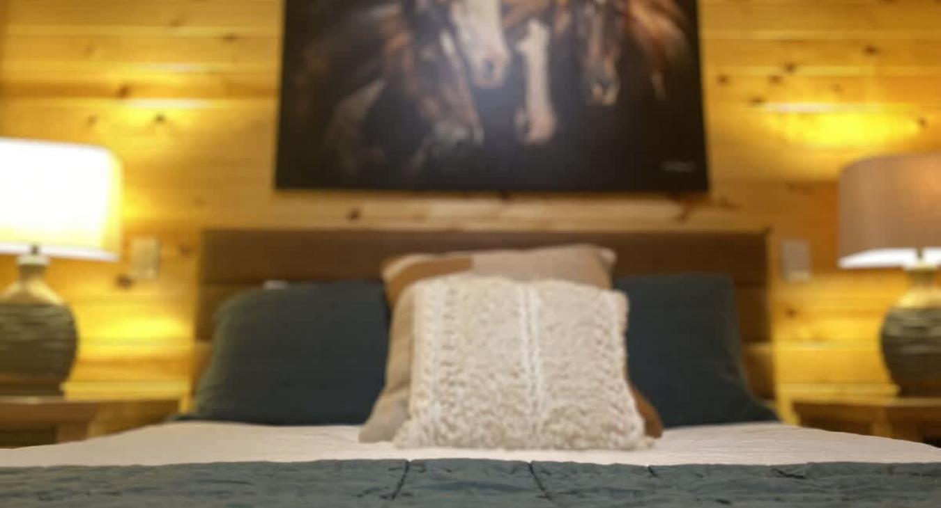 The second bedroom mirrors the first, with its own unique charm but a similar rustic atmosphere with a Queen size bed.